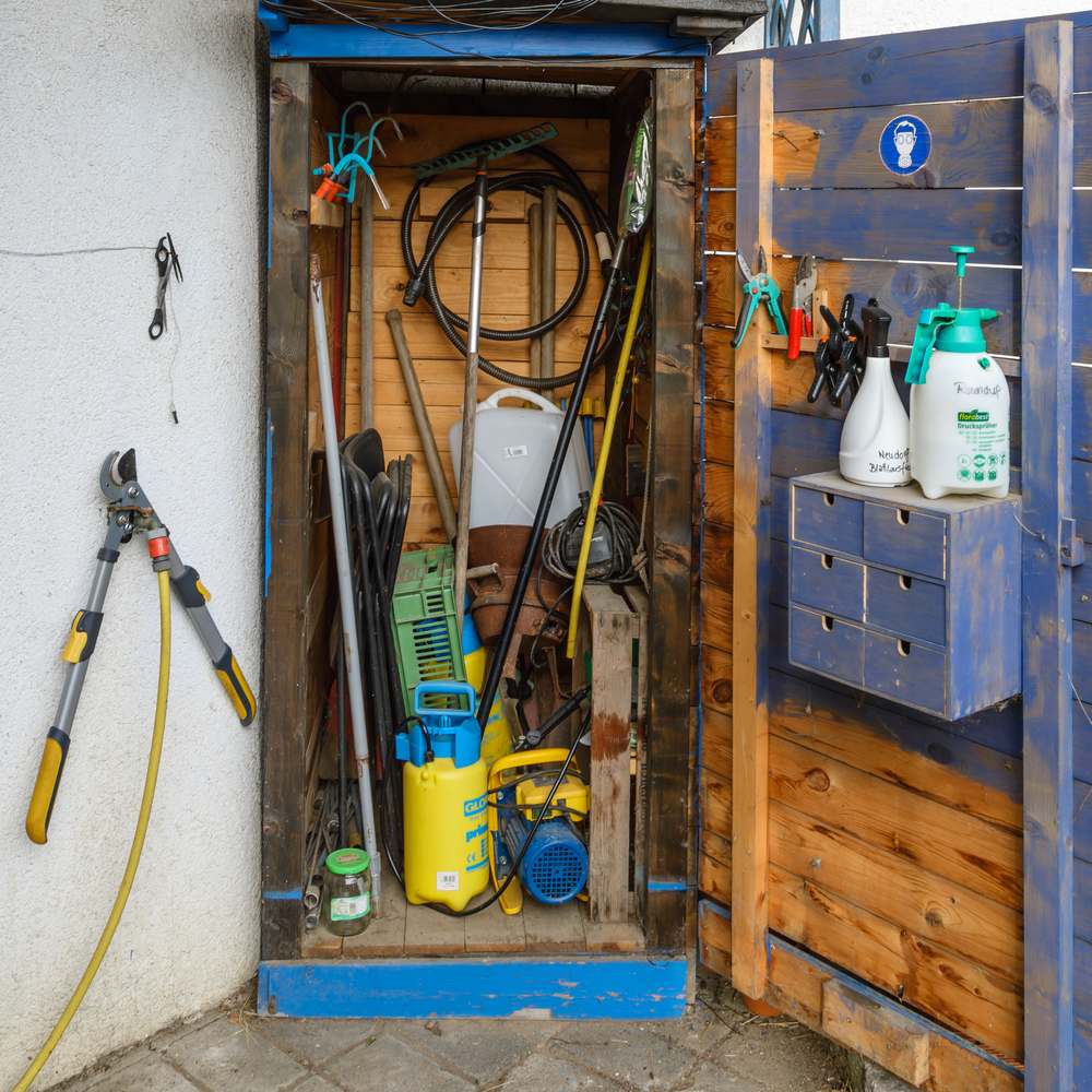 Garden tool shed interior with equipment stored off the floor