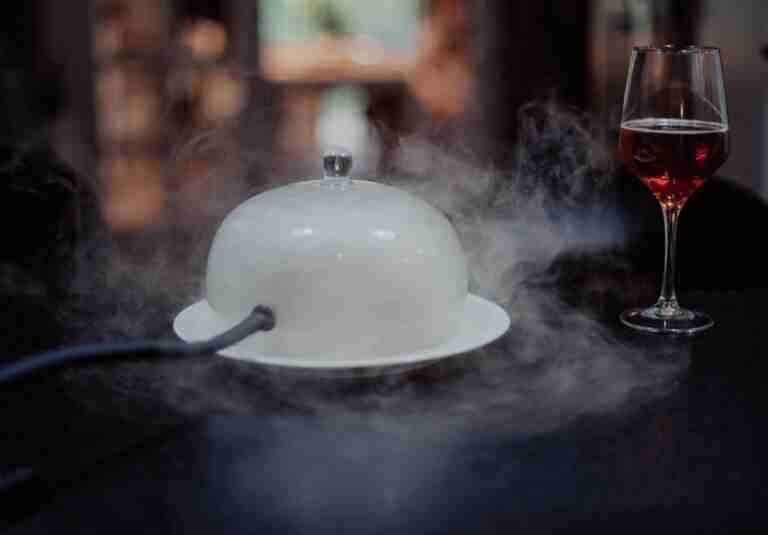 Smoke-infused dish with wine creates an elegant dining experience.