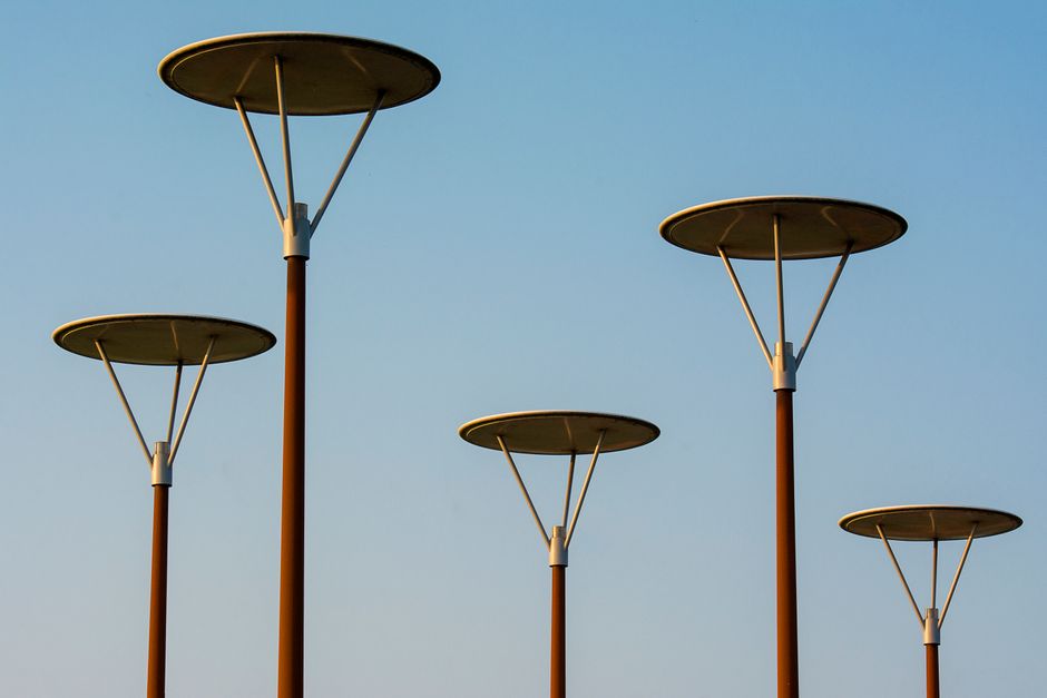 Elegant urban street lamps with a modern design against a clear sky.
