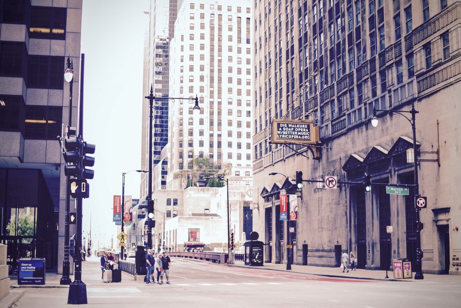 Dynamic urban street scene in downtown Chicago featuring iconic skyscrapers and bustling city life.